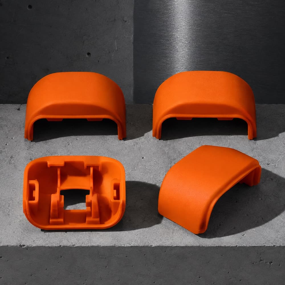 Four moulded wheel shrouds arranged in a square, one flipped to show its clips.